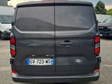 the back of a grey van parked in a parking lot