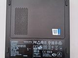 a black laptop with a red button on it