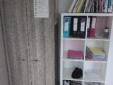 a bookcase and a cabinet in the corner of a room