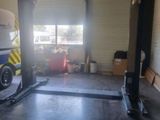 an image of a garage with a car on a lift