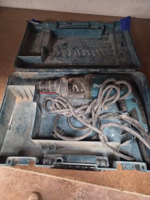 une boîte contenant une perceuse et une cordelette