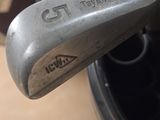 the wedge of a golf club with the name of the player on it