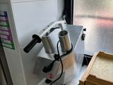 a machine that is sitting on a counter next to a stack of books