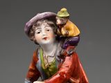 a figurine of a woman with a child on her back
