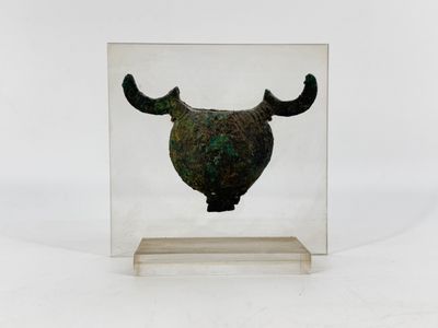 a glass box with a metal object inside of it