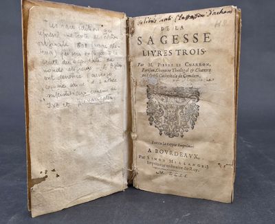 an old book with writing on it sitting on top of a table