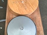 a wooden table with a metal disc on top of it