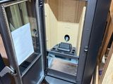 a small metal cabinet with a door open in a room