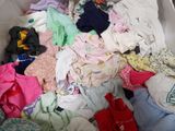 a large pile of clothes in a bin on the floor