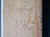 a close up of a piece of wood with writing on it