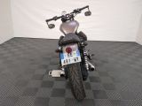 a motorcycle that is parked in a room with a checkered floor