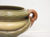 a large vase with two handles on a white surface