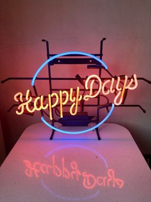 the neon sign is on top of a table in a room