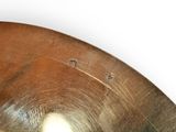 a close up of a metal object on a white surface