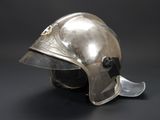 silver helmet on a black background with a blue emblem on the side