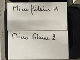 two pieces of paper that have been written on them
