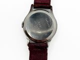 a close up of a watch on a white surface