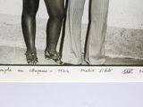 a black and white photo of two women standing next to each other