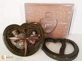 a heart shaped box with chocolates inside of it
