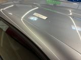 a sticker on the hood of a silver car
