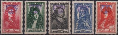 a close up of four different colored stamps on a black background