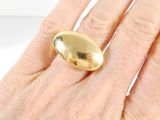 a woman ' s hand with a gold ring on it