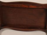 an old wooden tray with a handle on a white background