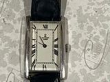 a watch that is sitting on a table with a tag attached to it