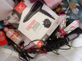 a box of hair dryers and other items on a bed