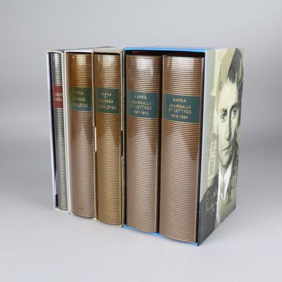 three books are stacked on top of each other on a table