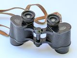 a pair of binoculars that are sitting on a white surface