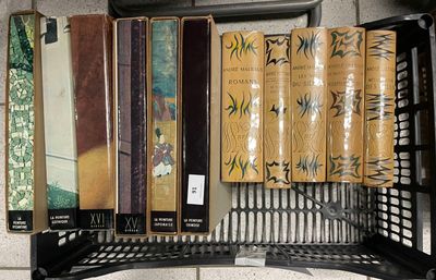 many books that are on a shelf in the room