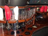 a bar with a lot of wine glasses on the counter