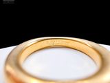 an image of a gold ring with a blue stone