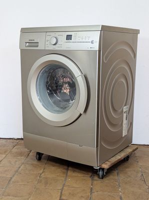 an image of a washing machine on wheels on a tiled floor