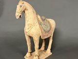 statue of a white horse with a saddle on a gray background