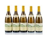 six bottles of wine are lined up on a white surface