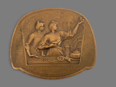 an image of a bronze medal depicting a man and woman