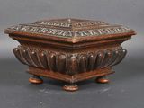 an old wooden box sitting on top of a wooden stand