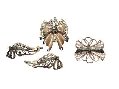 three pieces of silver and black metal jewelry on a white background