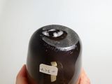 a person holding a bottle with a sticker on it