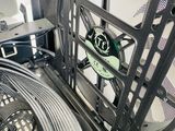 an image of a computer case with a fan and wires