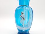a blue glass vase with a picture of a man on it