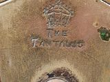 a brass clock with a crown on it on a table