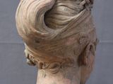 a statue of a woman with a bun on her head