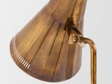 an antique brass table lamp with a wooden base and a brass shade