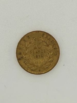 a close up of a gold coin on a white surface