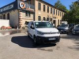 a white van parked in front of a building in a parking lot