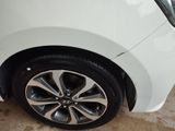 a close up of a white car with black rims