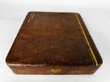 brown wooden box with gold trim on top of a white surface